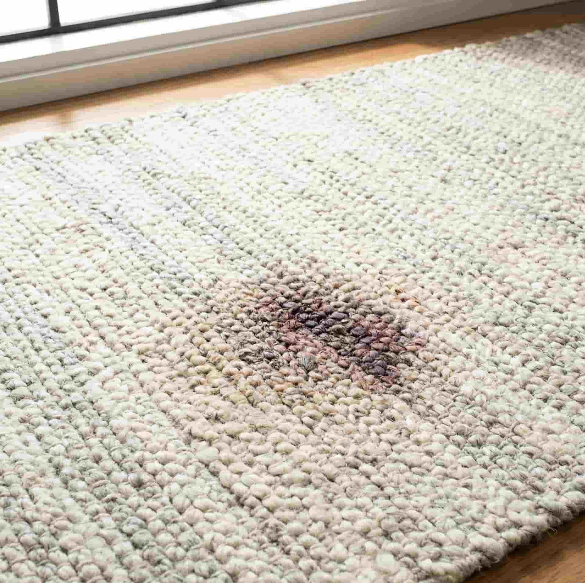 a wool rug with a stain