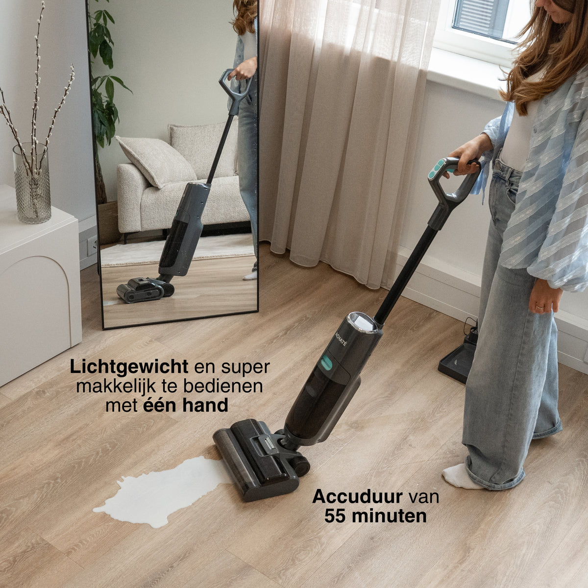 Cordless stick vacuum cleaner with black and teal design, used on hardwood floor with spilled liquid, shown as lightweight and easy to use with one hand.