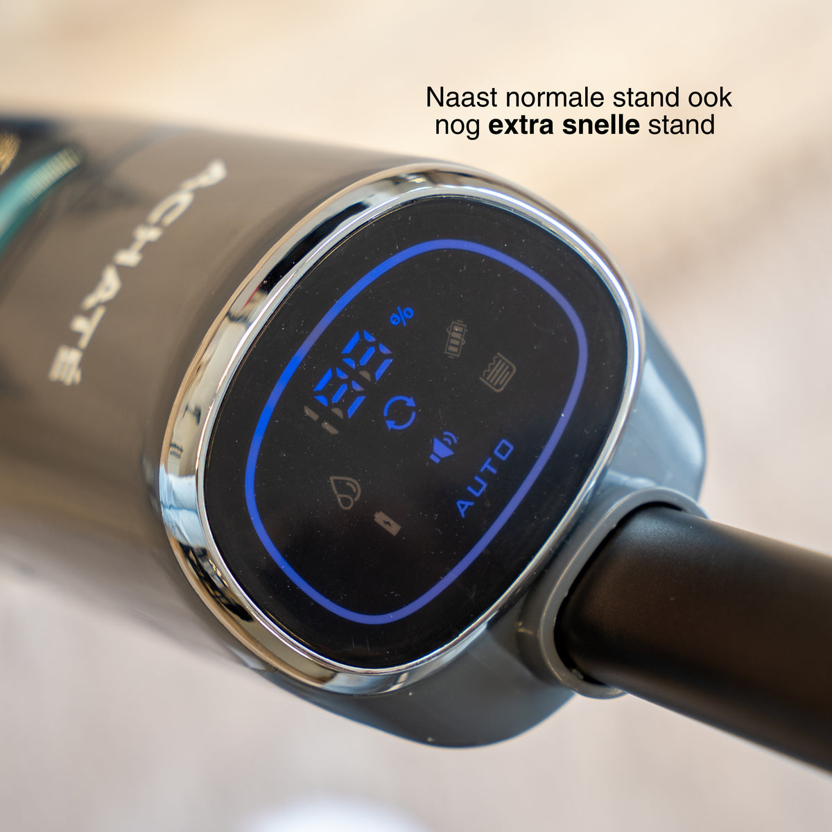 Close-up of a modern handheld steam cleaner digital display showing 65% battery, auto mode, and various function icons on a dark surface with chrome trim.