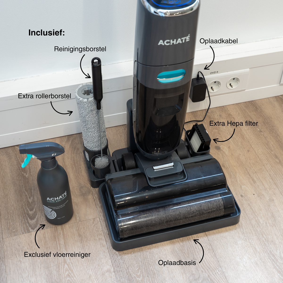 Cordless stick vacuum cleaner with roller brush, extra cleaning brush, extra Hepa filter, charging base, and auxiliary spray bottle on wooden floor.