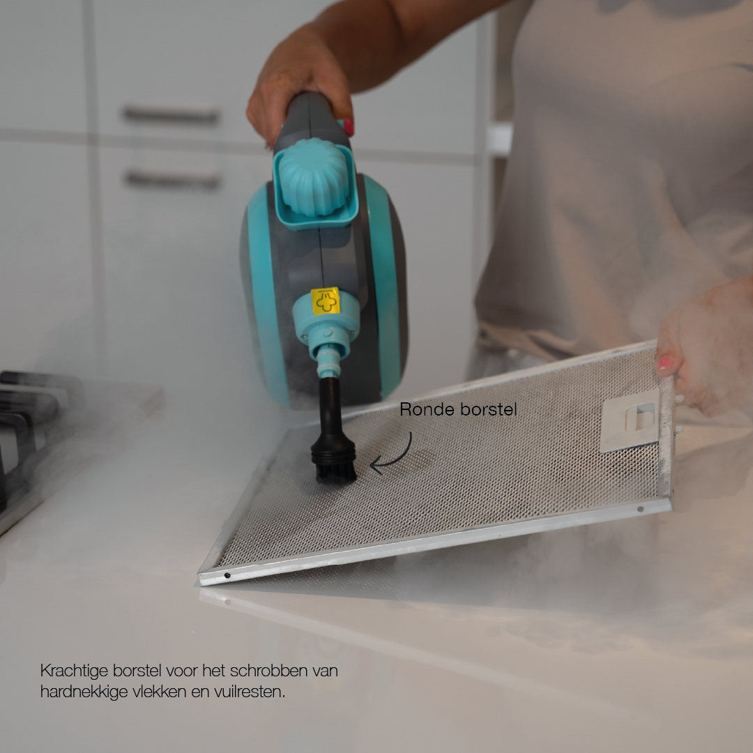 Handheld steam cleaner with round brush attachment cleaning a metal mesh filter, demonstrating powerful steam and scrubbing action.