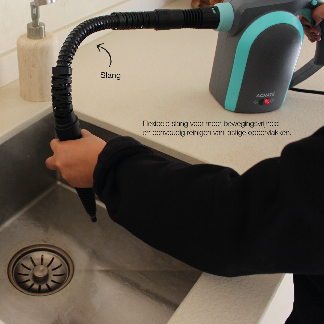 Handheld steam cleaner with flexible hose attachment being used to clean a kitchen sink drain, demonstrating multi-surface cleaning ability.