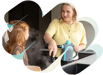 Woman using an Achaté handheld steam cleaner on a kitchen counter as a child watches.