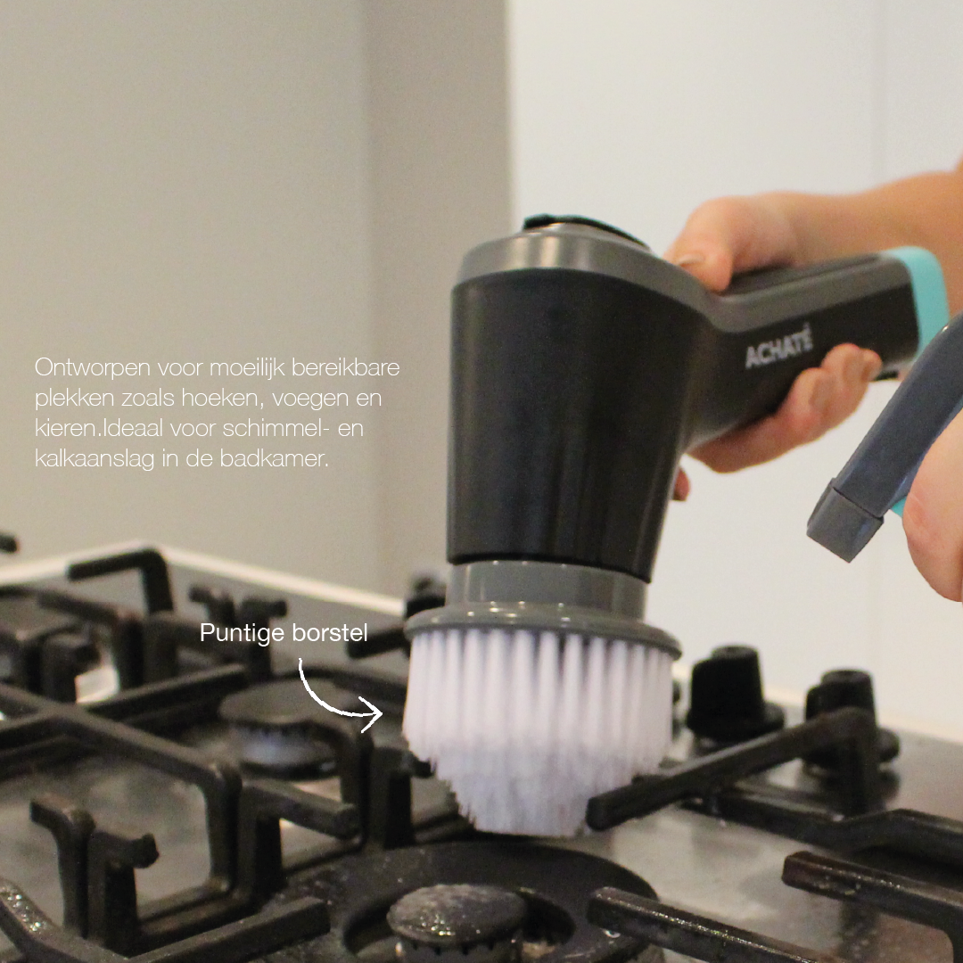 Handheld steam cleaner with a round white brush attachment cleaning a black stovetop burner grate.